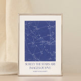 Framed star map print with a quote on a beige backdrop