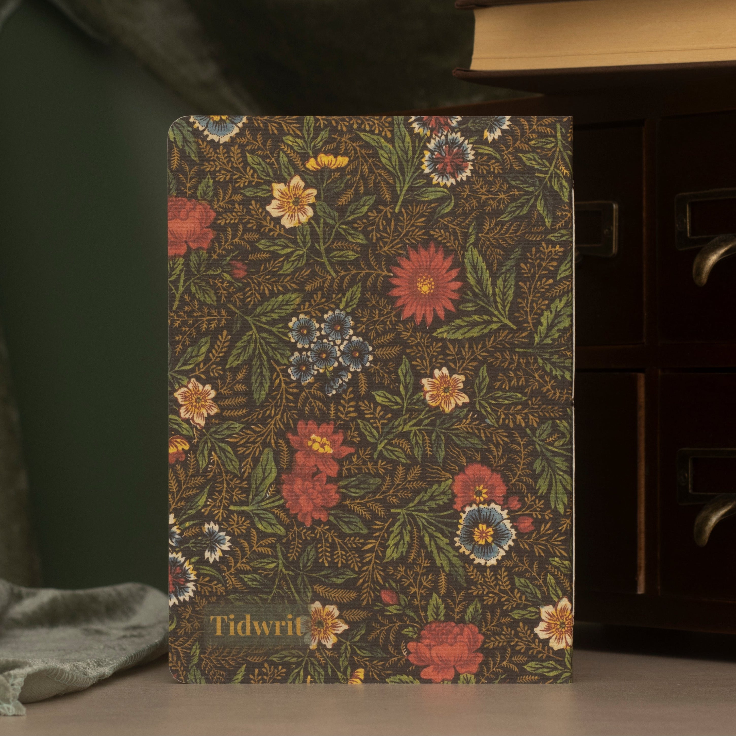 Floral-patterned notebook with 'Tidwrit' branding on a green background.